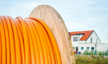 Large industrial roll of broadband cable wires in a rural community.